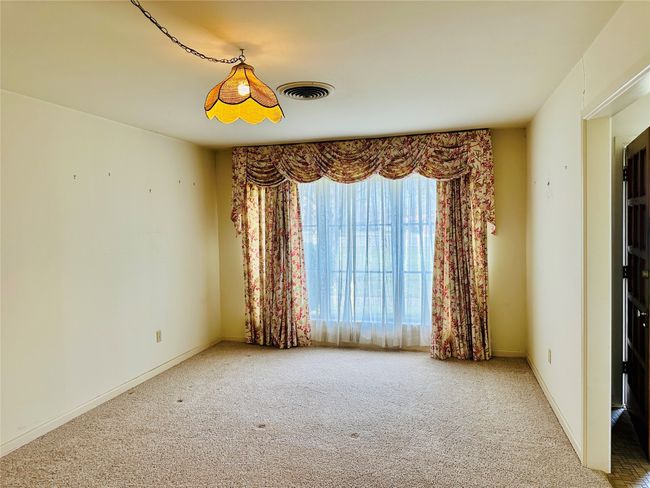 Carpeted spare room with visible vents and baseboards | Image 7