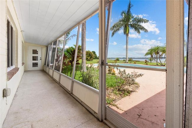Walk thru from the great room to the guest room and pool | Image 49