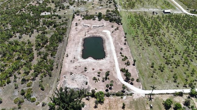 Aerial overview of property's location with a large body of water and rural landscape | Image 11