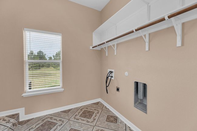Washroom with washer hookup, electric dryer hookup, and light tile patterned floors | Image 33
