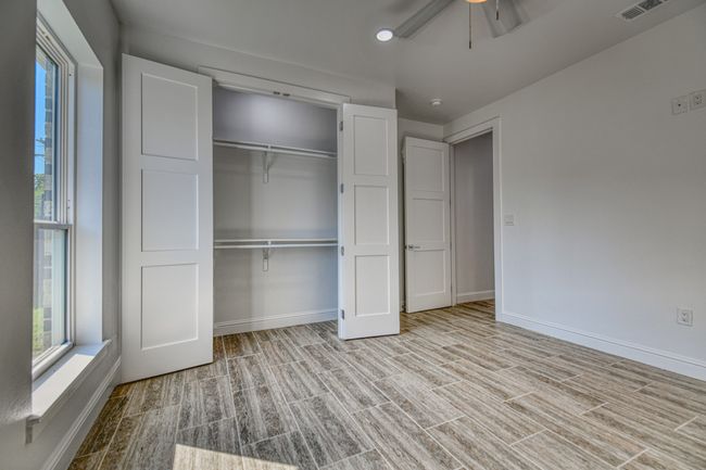 Unfurnished bedroom with light hardwood / wood-style flooring, a closet, and ceiling fan | Image 13