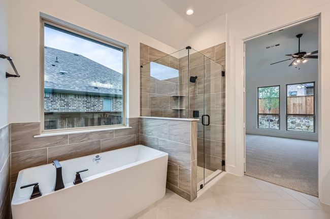 Bathroom featuring a shower stall, ceiling fan, visible vents, and a freestanding bath | Image 17