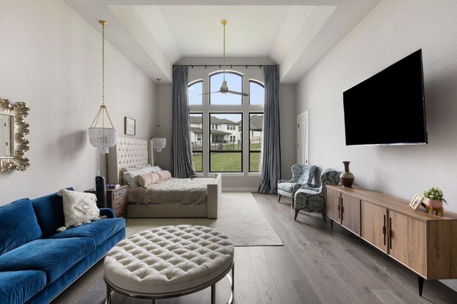 Living area with high vaulted ceiling and wood finished floors | Image 14