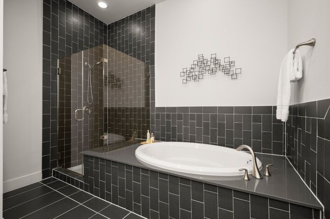 Bathroom with a bath, a tile shower, tile patterned floors, and recessed lighting | Image 18