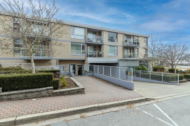 View of building exterior featuring uncovered parking | Image 27