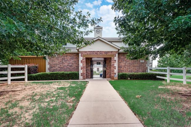 View of front of home featuring brick siding and a chimney | Image 32