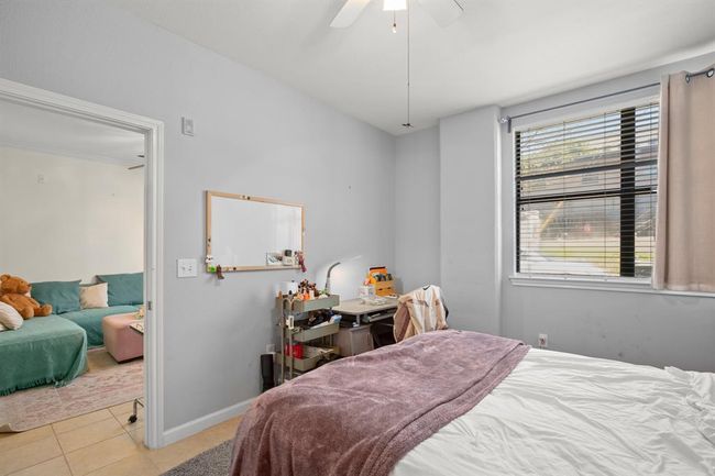 Bedroom featuring tile patterned floors and a ceiling fan | Image 14