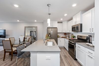 (Photo of decorated model, actual home's finishes may vary slightly) Open and inviting throughout, the stunning kitchen will be a focal point of gatherings for years to come. | Image 3