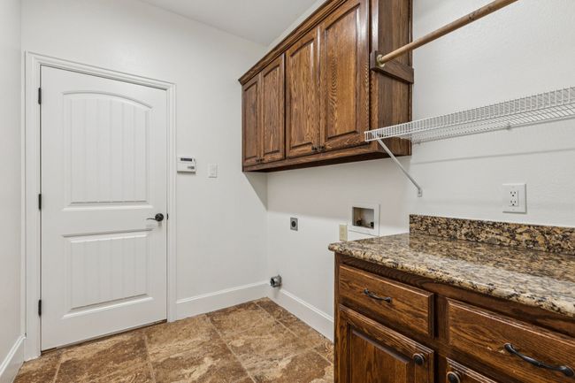 Laundry room with plenty of extra storage and hanging space. | Image 16