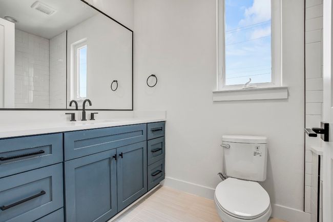 Bathroom featuring baseboards, healthy amount of natural light, vanity, and toilet | Image 20