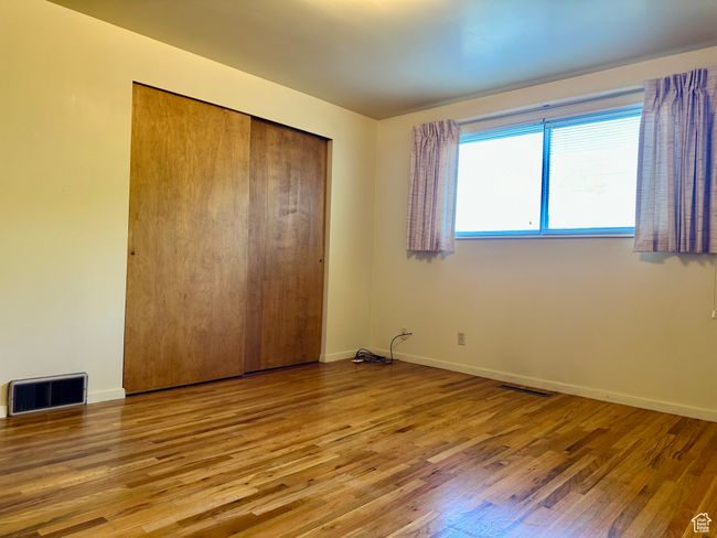 Unfurnished bedroom featuring wood finished floors and a closet | Image 14