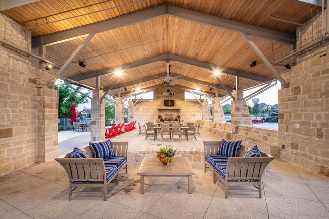 View of patio featuring a gazebo, an outdoor living space with a fireplace, and outdoor dining area | Image 37