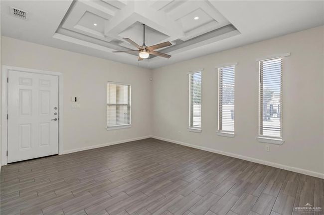 Unfurnished room with coffered ceiling, ceiling fan, wood finished floors, beamed ceiling, and recessed lighting | Image 5