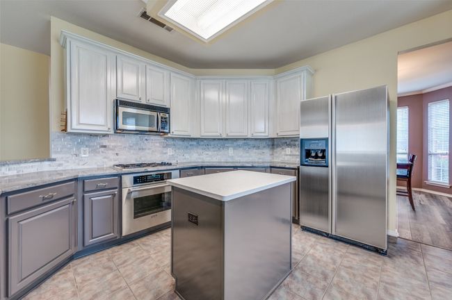 Kitchen with stainless steel appliances and Thermador gas range. | Image 12