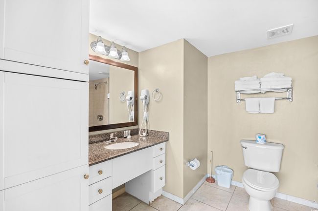 Full bath with toilet, vanity, visible vents, tile patterned floors, and baseboards | Image 23
