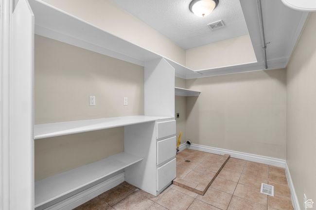 Washroom with light tile patterned flooring, laundry area, electric dryer hookup | Image 14