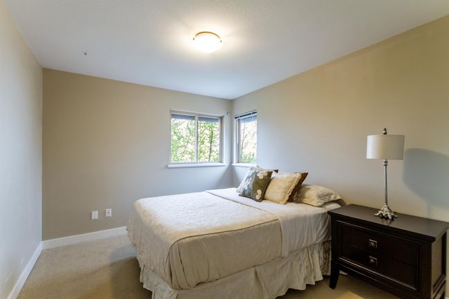 Bedroom with baseboards and light colored carpet | Image 21