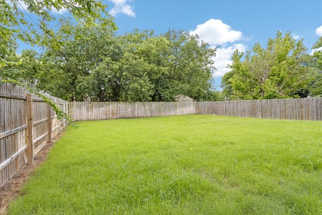 View of fenced backyard | Image 17