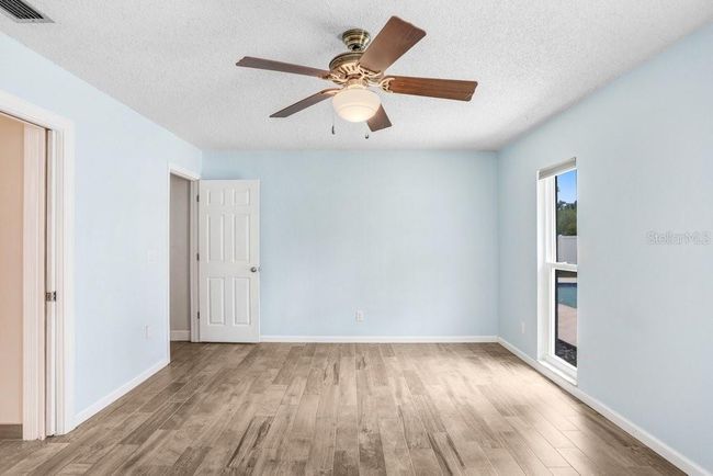 Primary bedroom with beautiful tile and updated bathroom | Image 14