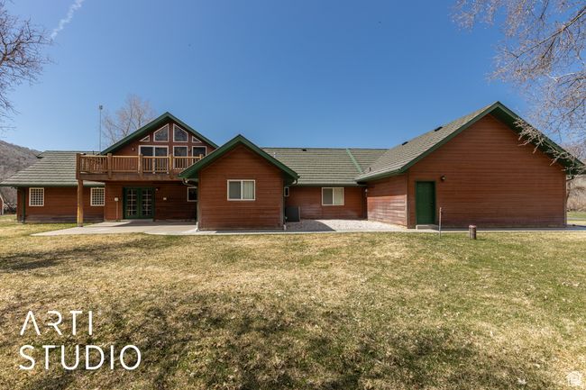 Rear view of property featuring french doors, a yard, a patio area, and a wooden deck | Image 47