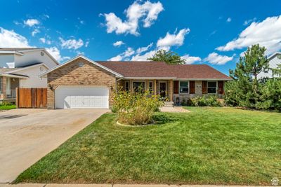 Single story home with a garage and a front yard | Image 2