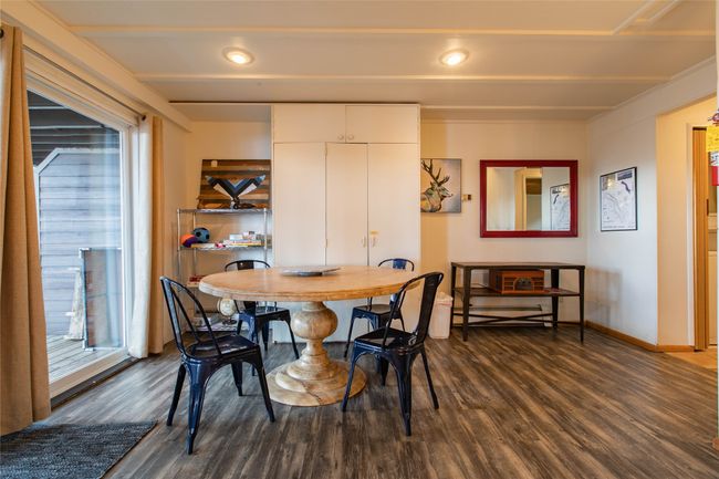 Dining space with a healthy amount of sunlight, beamed ceiling, baseboards, and dark wood-style floors | Image 11