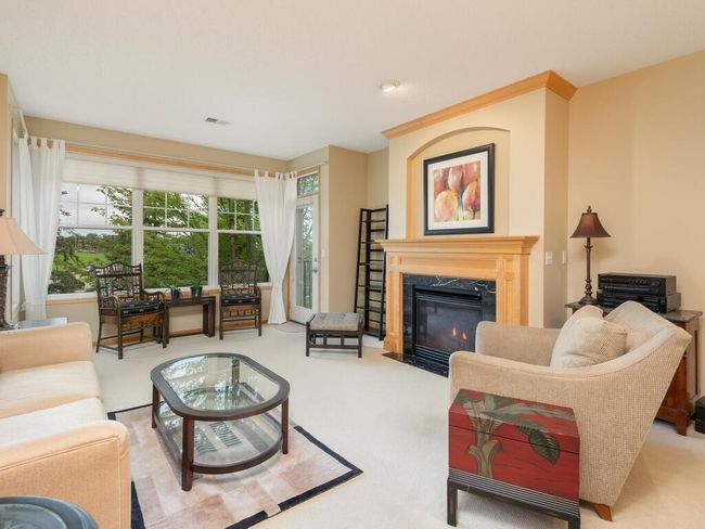 Living room with gas fireplace and door to deck. | Image 4