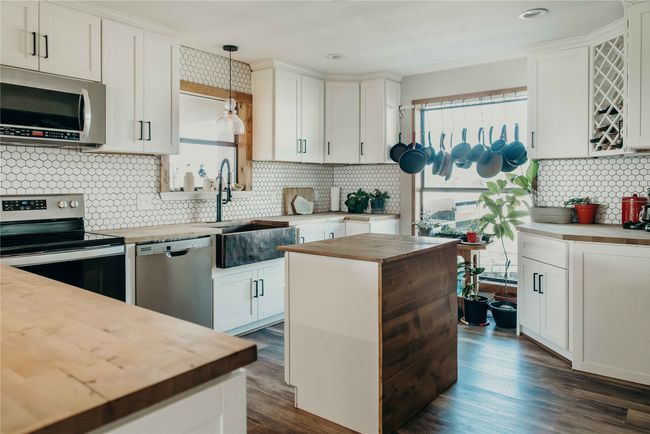 Kitchen with wood counters, stainless steel appliances, healthy amount of natural light, backsplash, and recessed lighting | Image 10