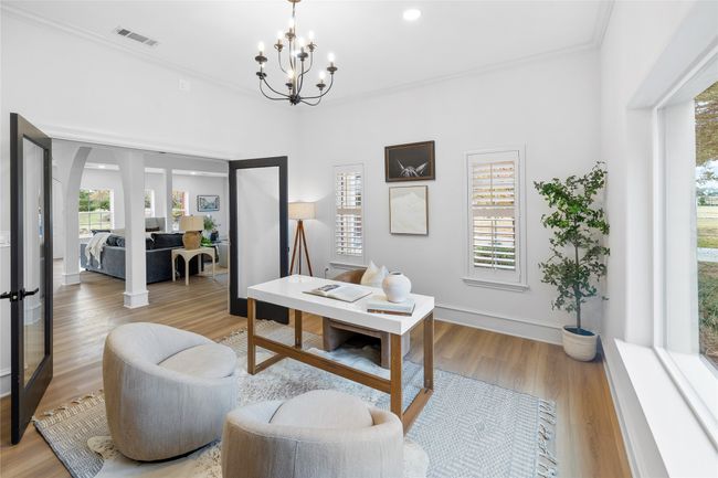 Living room with ornamental molding, a chandelier, light wood-style flooring, and arched walkways | Image 26