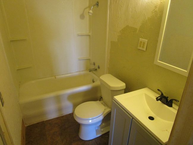 Full bathroom featuring toilet, vanity, and bathtub / shower combination | Image 15
