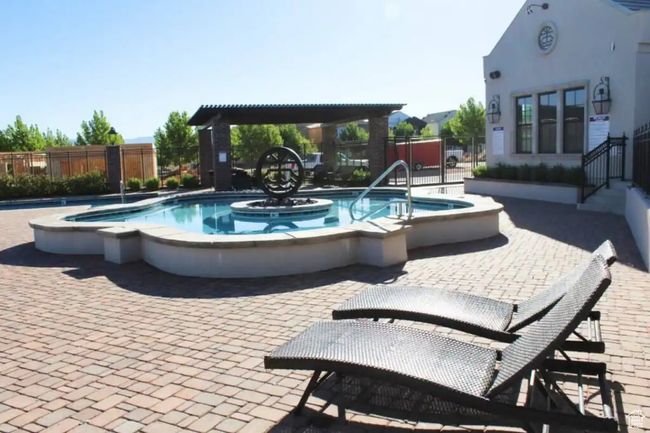 View of pool featuring a hot tub and a patio area | Image 49