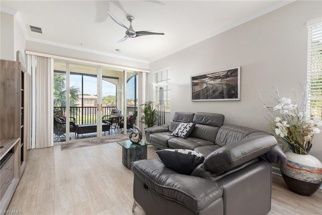 Living room featuring crown molding, ceiling fan, and light wood-type flooring | Image 6