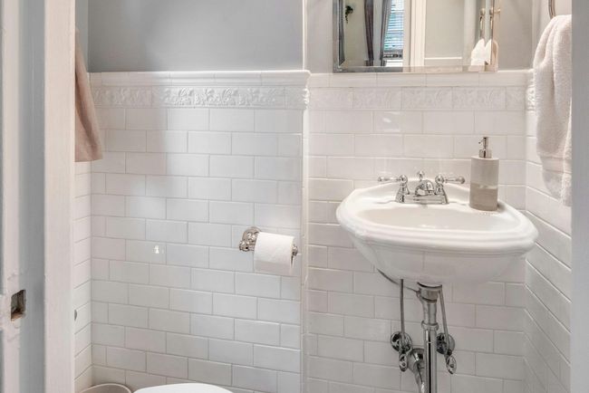 Half bathroom featuring toilet and tile walls | Image 14