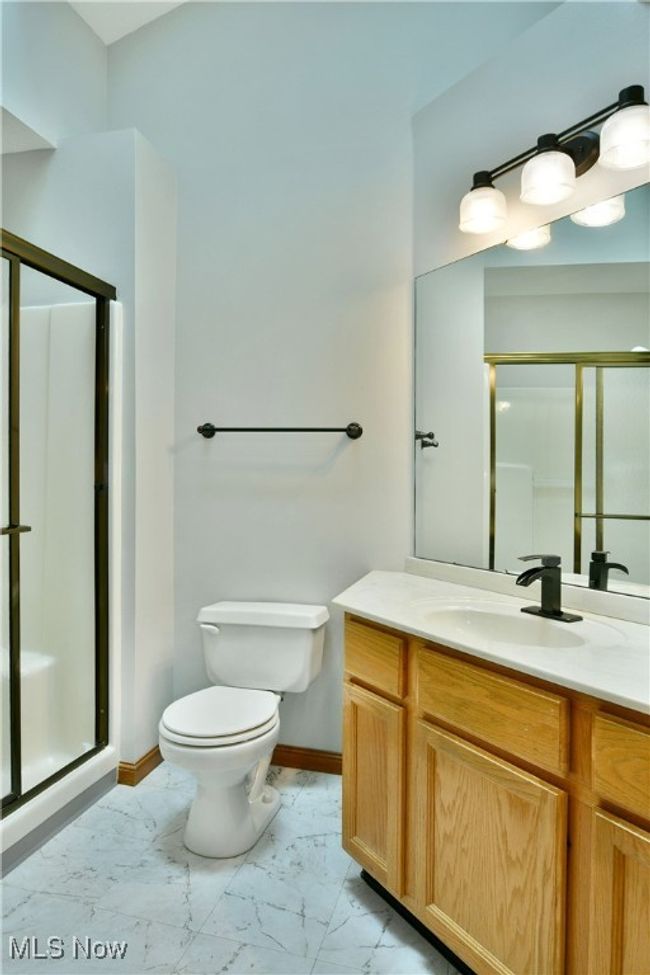 Full bathroom with marble finish floors, a stall shower, and vanity | Image 32