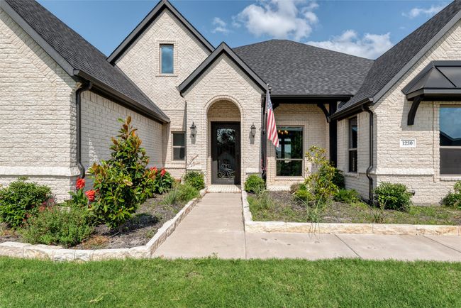 French provincial home with a shingled roof and brick siding | Image 4