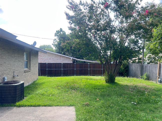 View of fenced backyard | Image 10