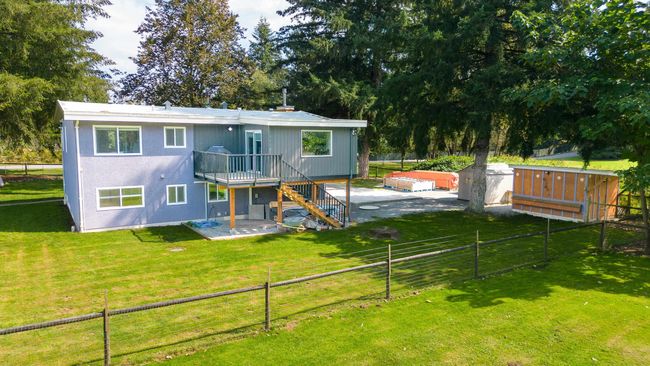 Rear view of property featuring stairway, a patio, and a deck | Image 33