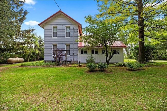 Rear view of house with a lawn | Image 17