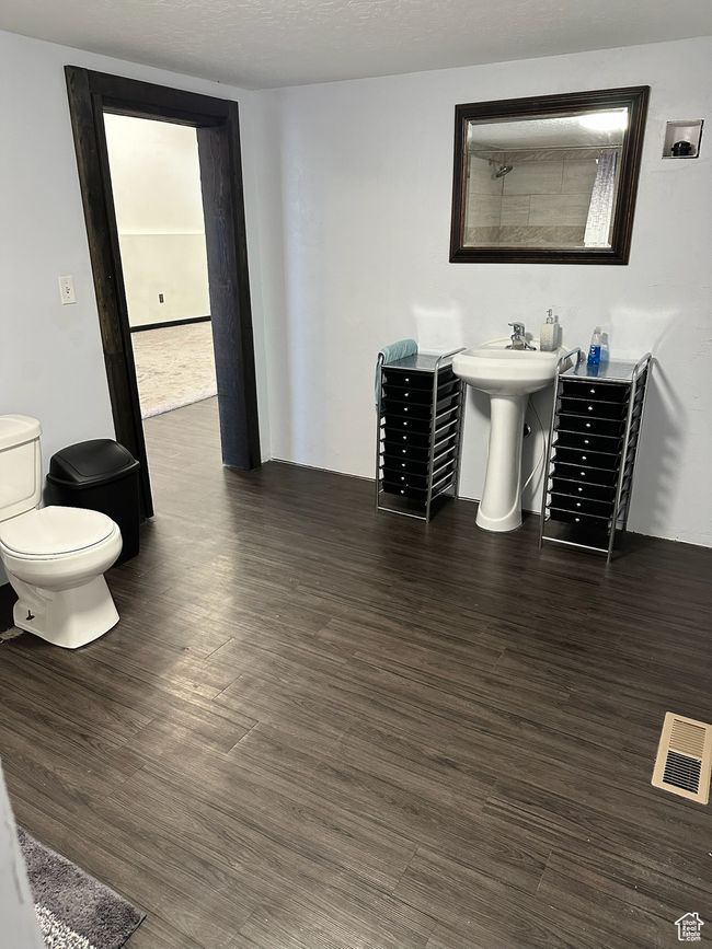 Bathroom with wood-type flooring, toilet, and sink | Image 26