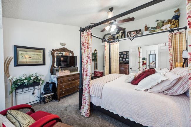 Carpeted bedroom with a ceiling fan | Image 19