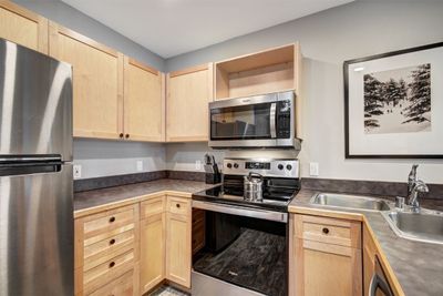 Kitchen with sink, light brown cabinetry, and stainless steel appliances | Image 3