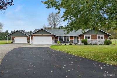 Discover this pristine 1, 636 sqft one-level home on 5 acres with detached garage/shop in picturesque Bordeaux Ranch, a haven for horse lovers! Enjoy breathtaking pastoral views from your oversized patio, or savor sunrises beside Mt. Rainier from your spacious front patio. Vaulted living room & picture windows enhance this 3BR/1.75BTH home. Lovingly cared for, upgrades to this home are many, including NEWER ROOF, gutters, & siding, remodeled baths, all plumbing re-done to PEX, newer paint & flooring, heat pump, along with a beautifully updated kitchen with newer propane stove & granite counters. 30x24 detached garage with 220v wiring for all your shop work. Fully fenced 4.15 acres of pasture for cattle or horses. Come and live the good life! | Image 1