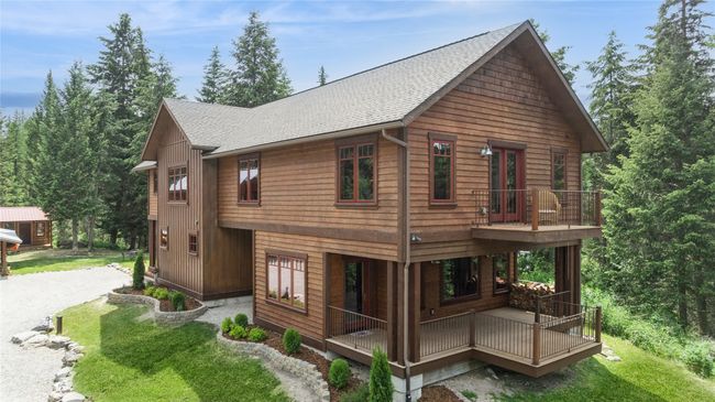 View of the property exterior with a balcony and a lawn | Image 4