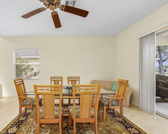 Dining space featuring a ceiling fan, plenty of natural light, baseboards, and visible vents | Image 13