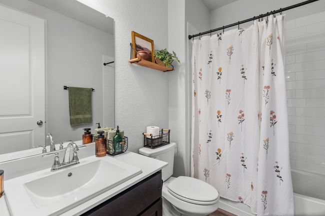 Full bath with vanity, shower / bath combo, and a textured wall | Image 22
