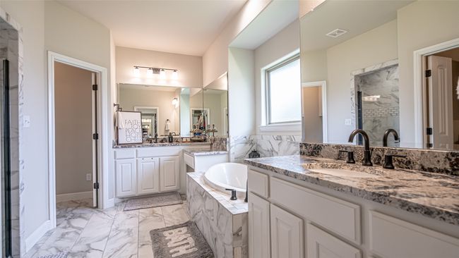 Primary bath featuring garden tub, separate shower, separate vanities, marble finish floors | Image 13