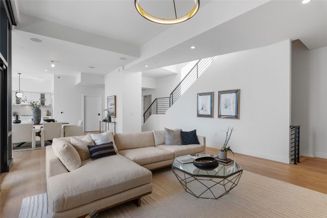 Living area with light wood-type flooring, recessed lighting, stairway, and baseboards | Image 8