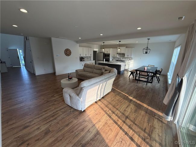 Living room featuring dark wood-style floors, baseboards, and recessed lighting | Image 29
