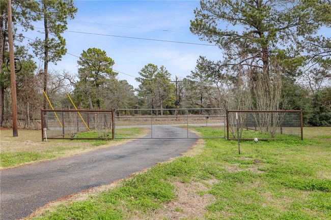 View of road featuring driveway, a gated entry, and a gate | Image 28