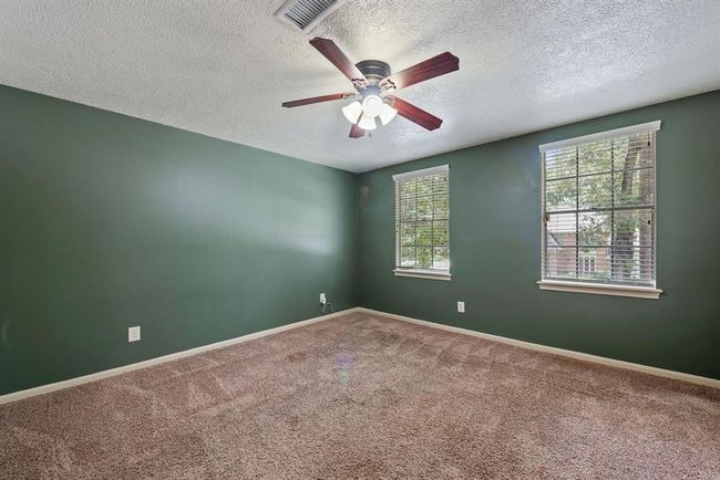 The last bedroom has two accent walls, lending a warm and cozy ambiance to the room. | Image 30